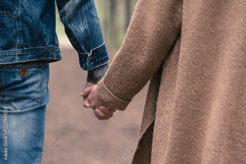 Couple in love holding hands close-up. Details, hands. Love, love story, valentine's day.
