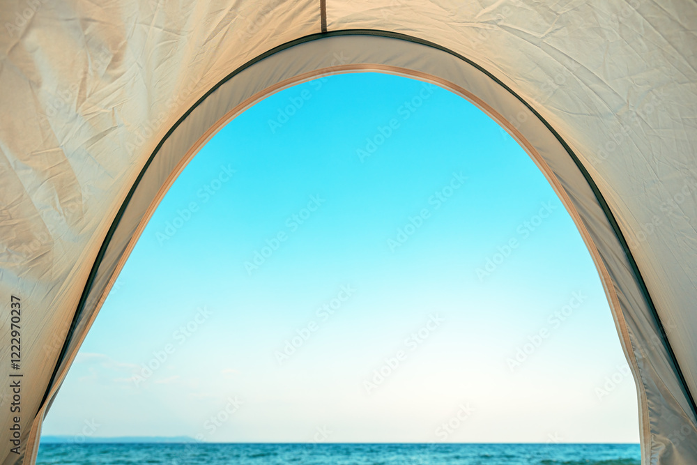 View of the horizon over ocean water from sun tent on the beach View of the horizon over ocean water from sun tent on the beach