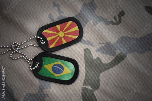 vintage army blank, dog tag with flag of macedonia and brazil on the khaki texture background. military concept. photo