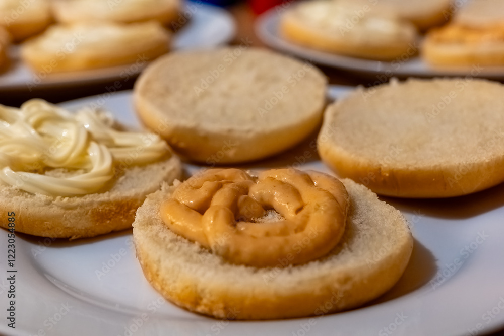 Various bread slices topped with creamy spreads, showcasing a simple food preparation activity at home Various bread slices topped with creamy spreads, showcasing a simple food preparation activity at home