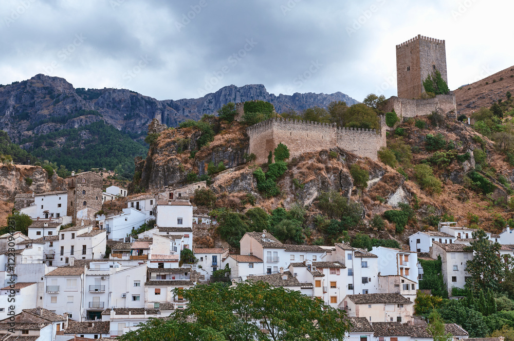 Fototapeta premium Charming historical hilltop village overlooked by a medieval castle and lush mountains