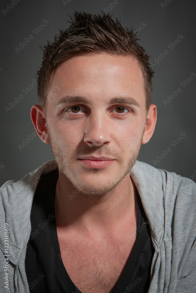 Obraz premium Male Model. A series of casual poses by a male model in the photo studio sets against a neutral backdrop.