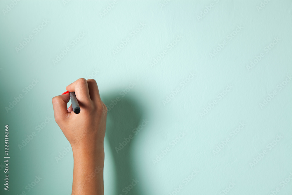 woman holding a white paint roller against color background woman holding a white paint roller against color background