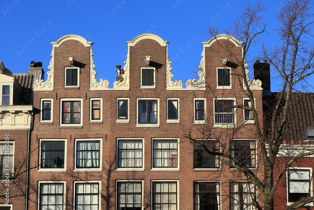 Fototapeta premium Amsterdam Keizersgracht Canal House Facades with Neck Gables and Blue Sky Close Up, Netherlands