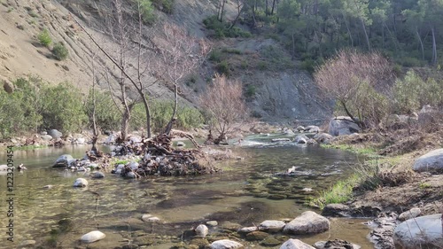 Passing through the Dokuzoluk Recreation Area in the Karaisali district of Adana province, the mesmerizing and tranquil view of Eglence River provides a restful sight perfect for a weekend activity. photo