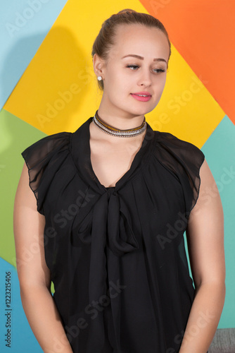 Obraz na płótnie A woman wearing a black dress and a necklace with shy look on face w salonie