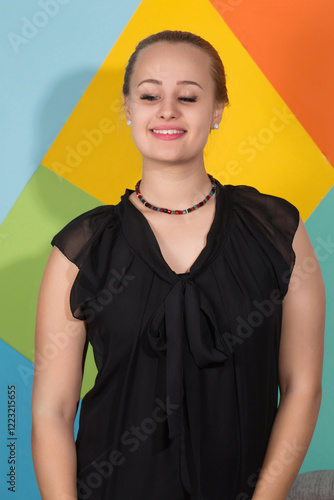 Cheerful woman in black dress and necklace