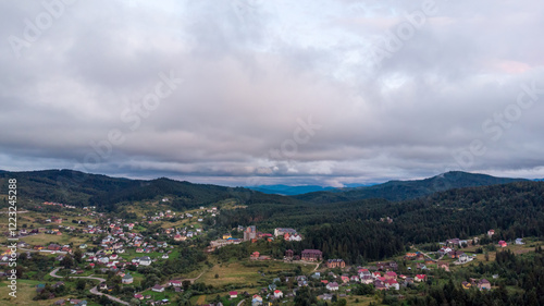 Wallpaper Mural Aerial View Of A City Surrounded By Majestic Mountains Under A Cloudy Sky. The Dramatic Landscape Creates A Stunning Contrast Between Urban Life And Natural Beauty.	
 Torontodigital.ca