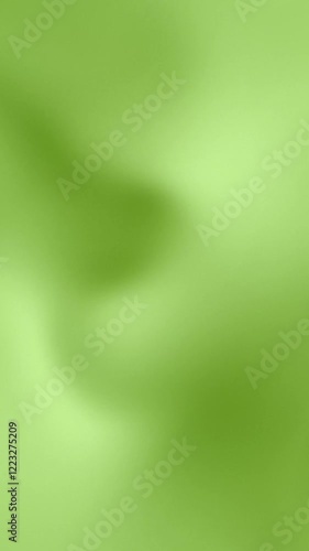 Moving background with green and pastel green colors. Smooth animation with gradient, liquid and fluid colors. Vertical video.
