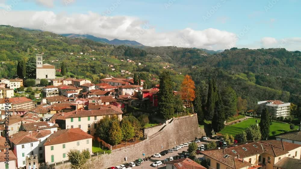 Beautiful aerial view of Barga, nestled in the Garfagnana valley, bathed in sunlight Beautiful aerial view of Barga, nestled in the Garfagnana valley, bathed in sunlight