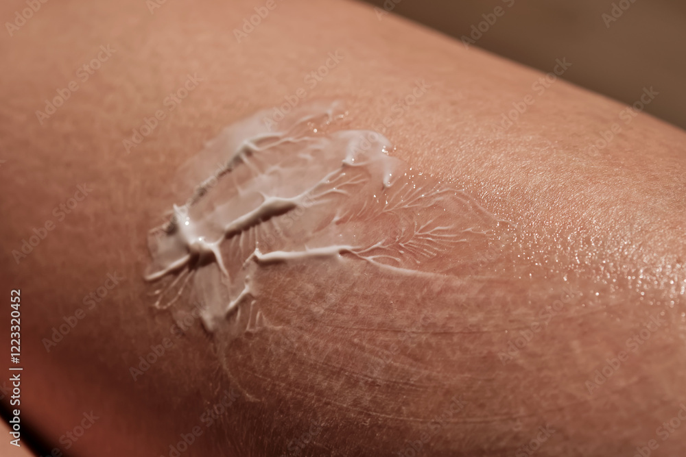 Obraz premium White body cream on dry human skin.