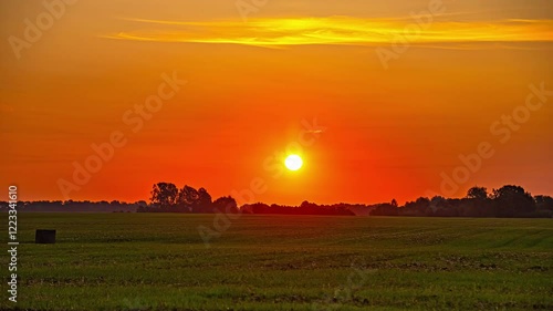 Wallpaper Mural Sunrise timelapse over a grass field. Bright, orange sunlight shines on an open rural landscape. Torontodigital.ca