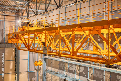 Yellow overhead crane in an industrial hall