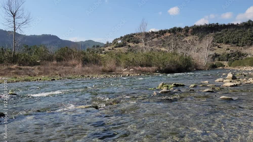 Flowing through the village of Cukur in the Karaisali district of Adana province, the mesmerizing and tranquil view of Eglence River provides a restful sight perfect for a weekend activity. Flowing through the village of Cukur in the Karaisali district of Adana province, the mesmerizing and tranquil view of Eglence River provides a restful sight perfect for a weekend activity.