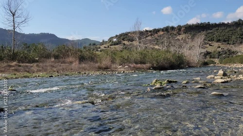 Flowing through the village of Cukur in the Karaisali district of Adana province, the mesmerizing and tranquil view of Eglence River provides a restful sight perfect for a weekend activity. photo