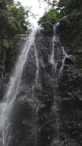 Powerful Waterfall Flowing Down Rocky Cliff in Slow Motion Vertical video