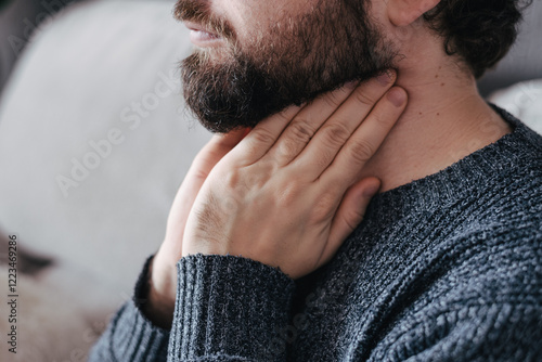 Sick man suffering from throat problems. Thyroid gland, painful swallowing, pharyngitis, laryngeal swelling concept. Inflammation of the upper respiratory tract