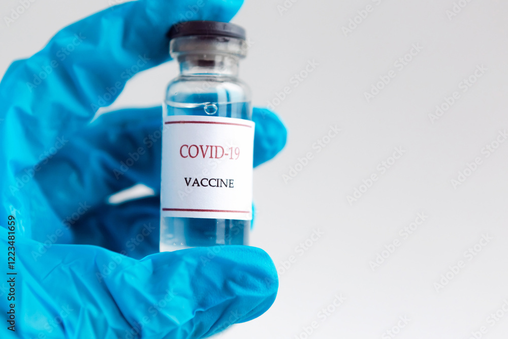 Doctor hand in gloves hold a bottle with vaccine. Coronavirus prevention concept Doctor hand in gloves hold a bottle with vaccine. Coronavirus prevention concept