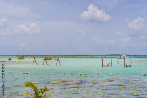 Turquoise waters of Bacalar Lake, Mexico. Peaceful and scenic tropical destination. Travel, relaxation, and nature concept photo