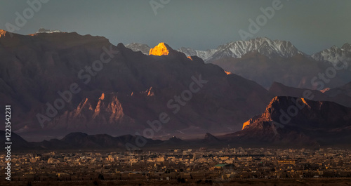 Sunrise view of a the ancient city of Yazd, Iran with a background of mountains in winter. 