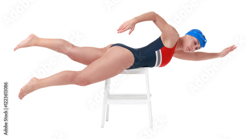 Professional sportswoman in swimsuit and cap practicing dryland swimming on white background photo