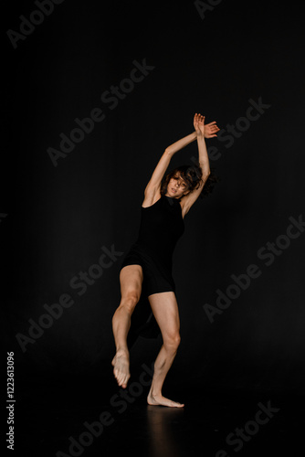 Wallpaper Mural Young slim woman in black outfit with bare feet dancing in dance studio Torontodigital.ca