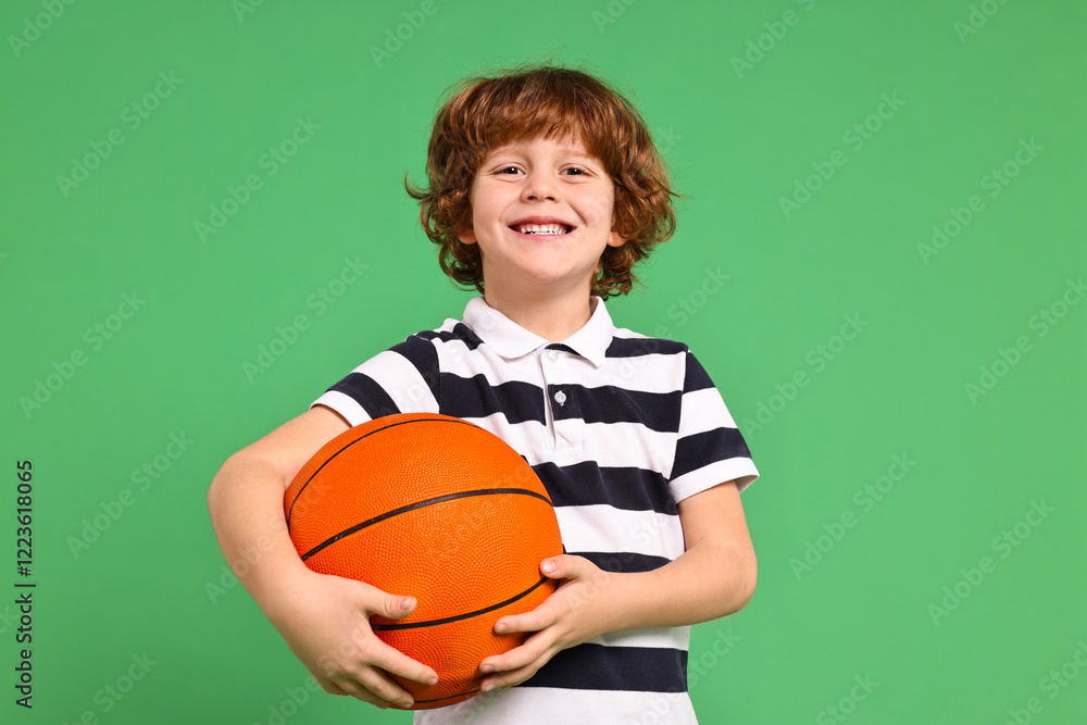 Little boy with basketball ball on light green background Little boy with basketball ball on light green background