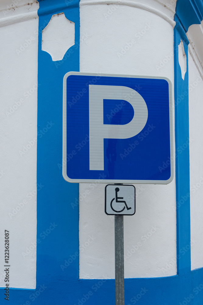 blue disabled parking sign by a blue and white wall blue disabled parking sign by a blue and white wall