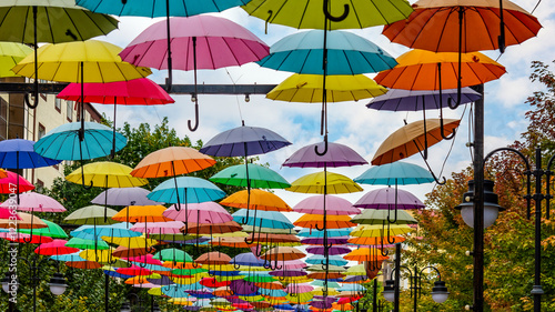 Wallpaper Mural Bright installation of multicolored umbrellas suspended in the air. The cityscape gets a festive look. Torontodigital.ca