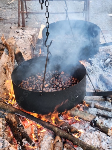 Cooking chesnuts in a cauldron on the fire, close-up
