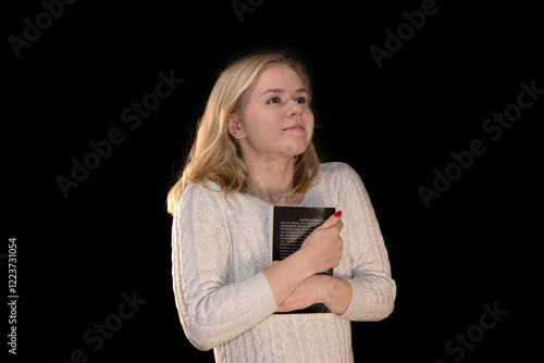 Happy Woman Embracing a Book with Joyful Expression