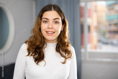 Positive young woman looking at camera and smiling. Portrait of woman. Free Download Positive young woman looking at camera and smiling. Portrait of woman. - GFXLoad