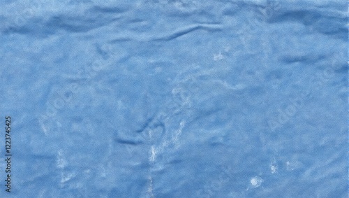 Soft blue chambray fabric with faded creases offering a comfortable and casual look