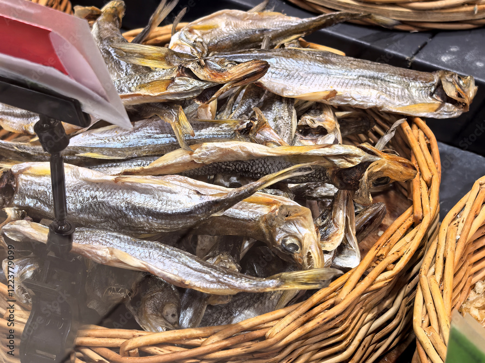 Dried fish displayed in a vibrant market during the afternoon sunlight