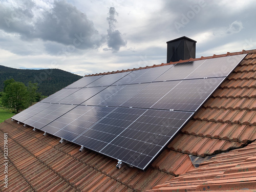 Red Tiled Roof of a Residential House with Installed Solar Panels