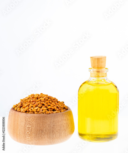 Bottle of fenugreek oil, organic seeds - Trigonella foenum - graecum. photo