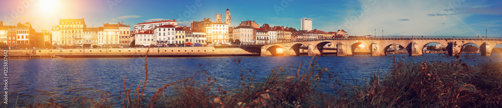 Obraz premium Panoramic view of city of Macon with Saone river on sunny autumn day, Burgundy, France..