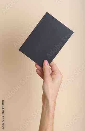 Woman's hand holding a black card