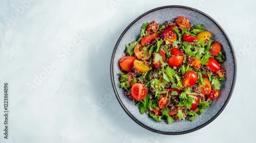 A vibrant quinoa salad with cherry tomatoes and parsley, served on white, photo