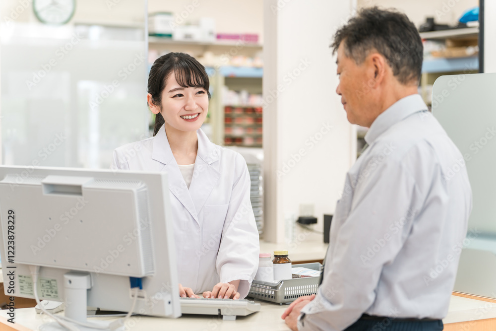 薬局でシニア男性患者に説明・服薬指導する薬剤師の女性
薬局でシニア男性患者に説明・服薬指導する薬剤師の女性