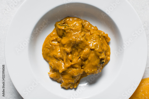 Overhead view of Nigerian owo soup with fish and beef in a white plate, top view of oghwo soup in a large dinner plate, traditional owo soup in a white dish photo