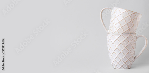 White ceramic cups on grey ...