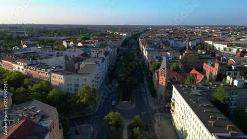 Elevated train navigating through a residential area in berlin, showcasing the city's urban transportation system. Amazing aerial view flight drone shot footage from above photo