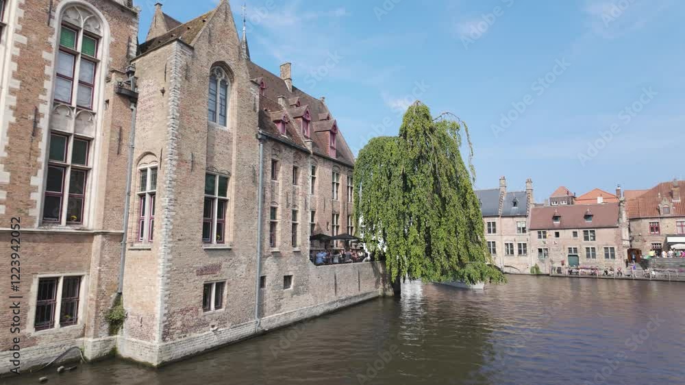 Scenic Bruges canal view at Rosary Quay, historic buildings and picturesque beauty Scenic Bruges canal view at Rosary Quay, historic buildings and picturesque beauty