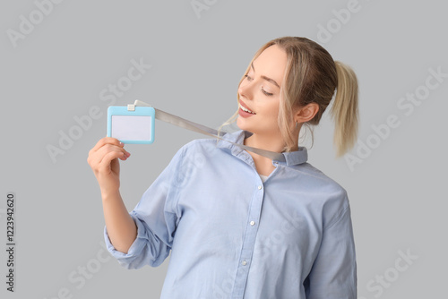 Young woman with blank badg...