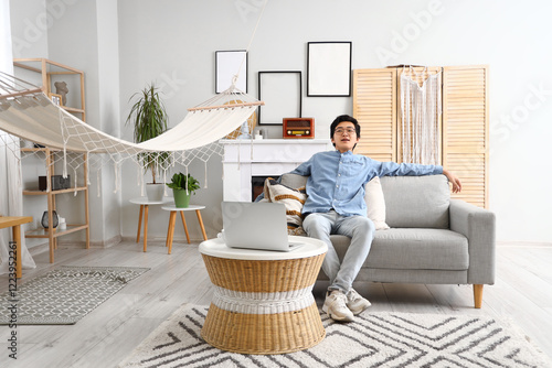 Young Asian man resting on ...