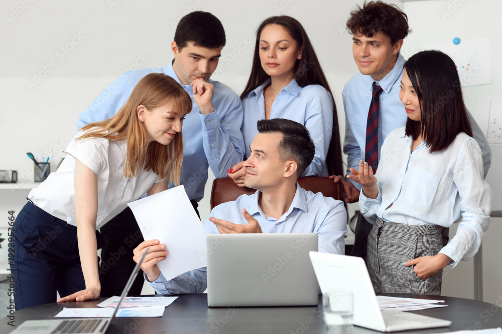 Group of business consultants working with laptop at table in office Group of business consultants working with laptop at table in office