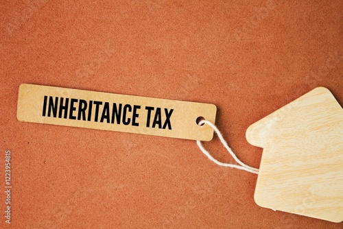 house form and paper tag with the word Inheritance Tax. An inheritance tax is a tax paid by a person who inherits money or property of a person who has died photo