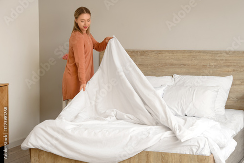 Pretty young woman making b...