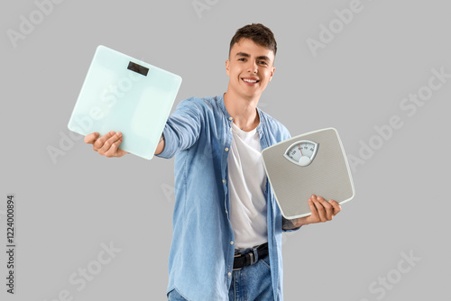 Young man with weight scale...